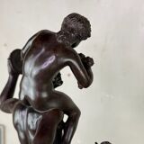 Dionysus on the shoulders of a satyr, bronze after the antique on a yellow Siena base.