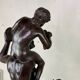 Dionysus on the shoulders of a satyr, bronze after the antique on a yellow Siena base.