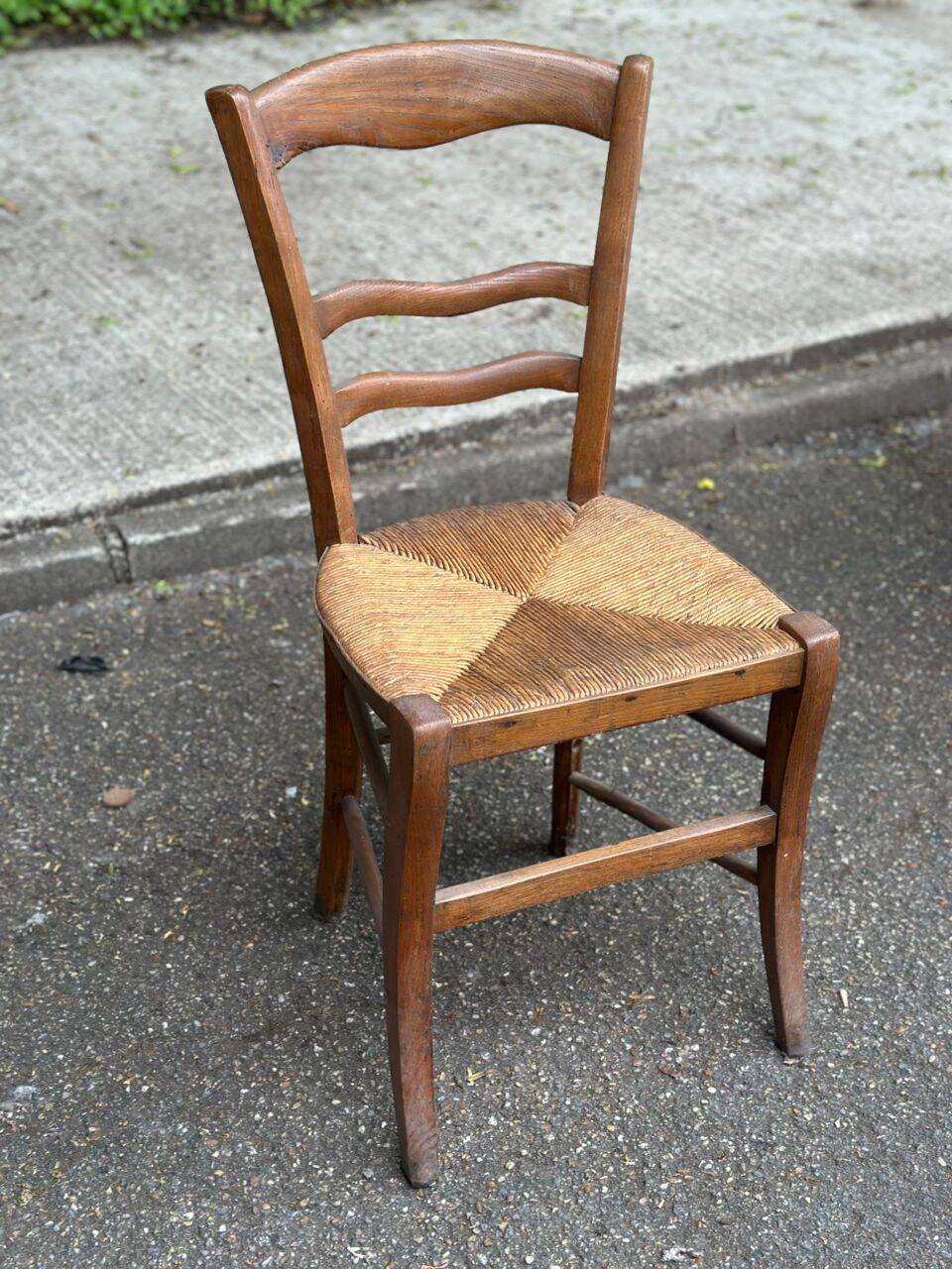 Period rustic chair with a straw seat