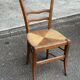 Period rustic chair with a straw seat