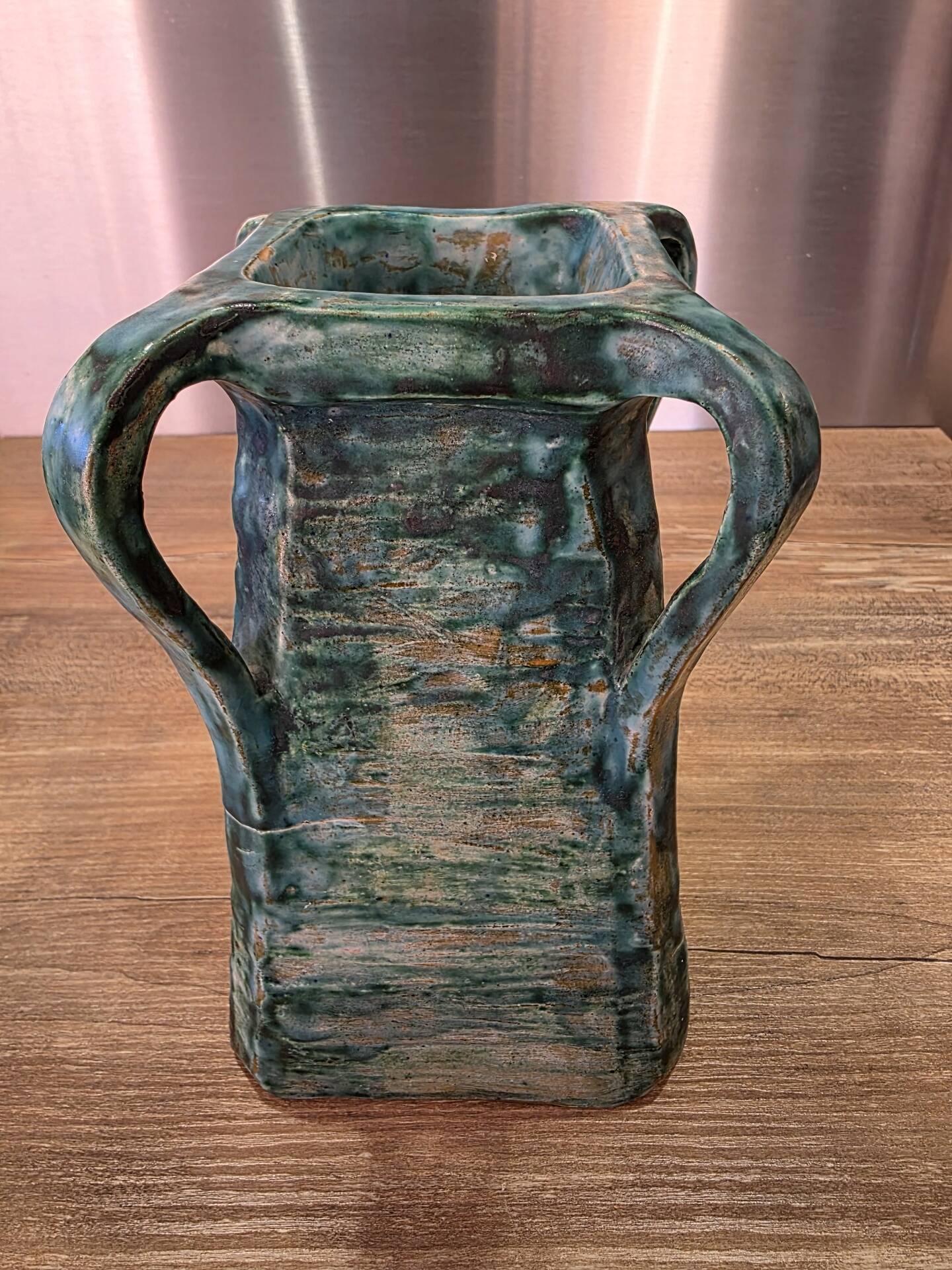 Vintage brutalist ceramic vase with 4 green handles.