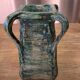 Vintage brutalist ceramic vase with 4 green handles.
