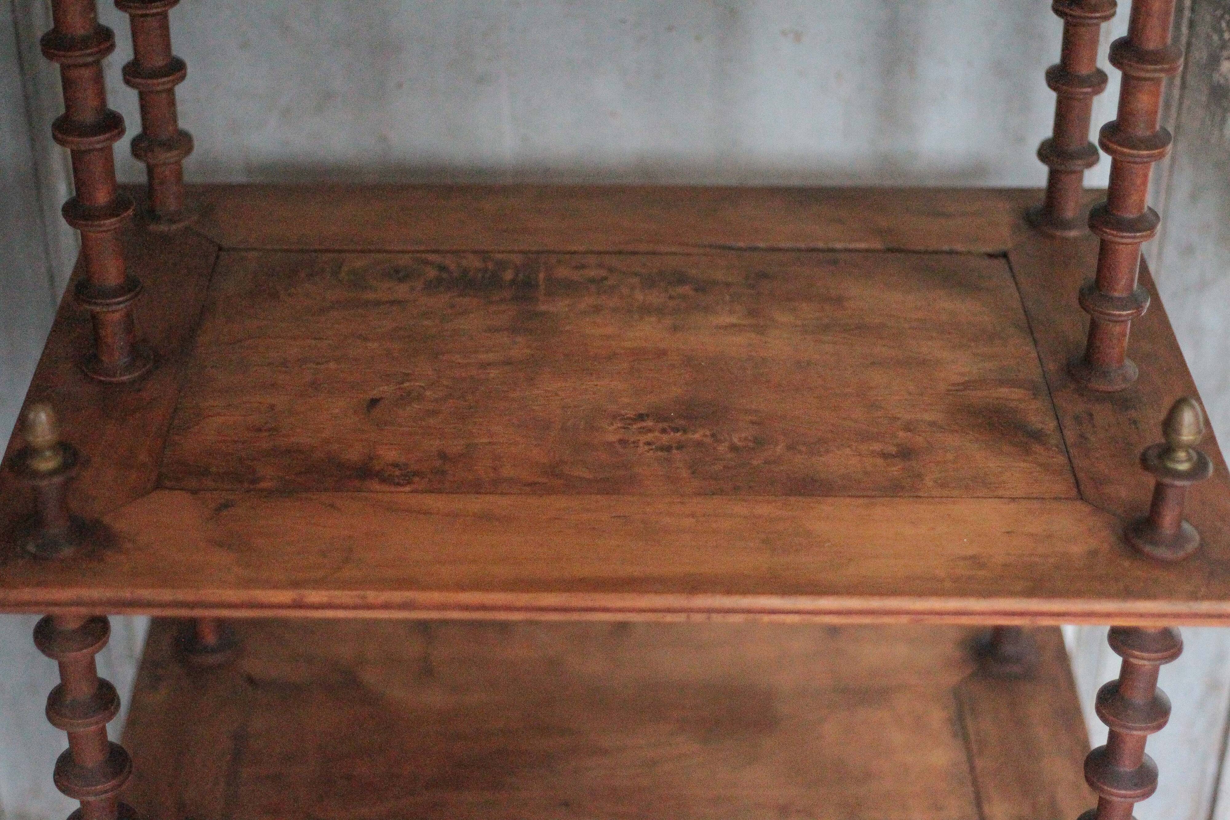 Napoleon III spool shelf, floor-standing shelf with brass tips.
