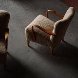 Pair of Mid Century Modern Swedish lounge chairs in birch and lamb's wool, 1960s.