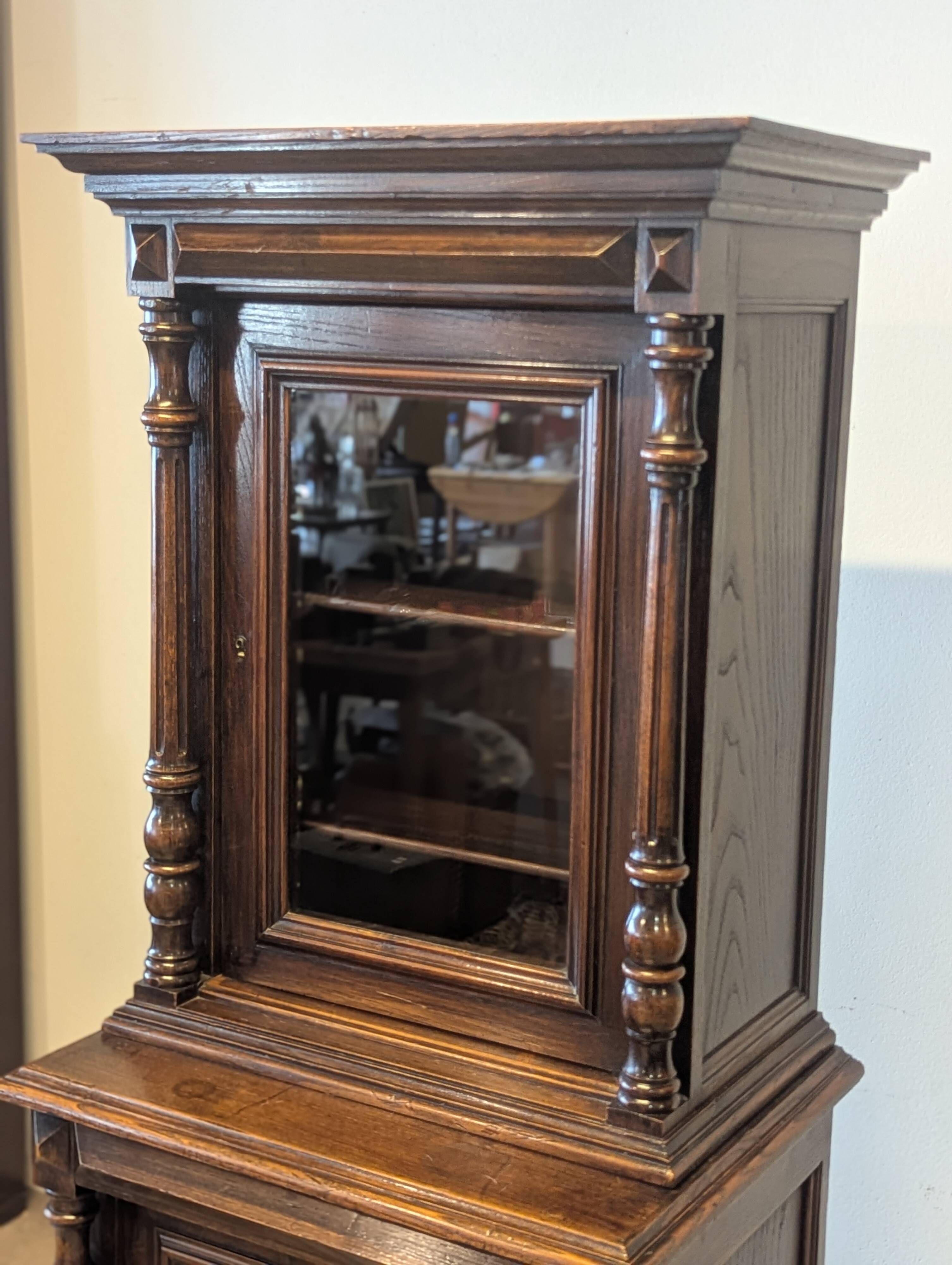 Two-body display cabinet in oak, Henri II style.
