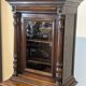 Two-body display cabinet in oak, Henri II style.