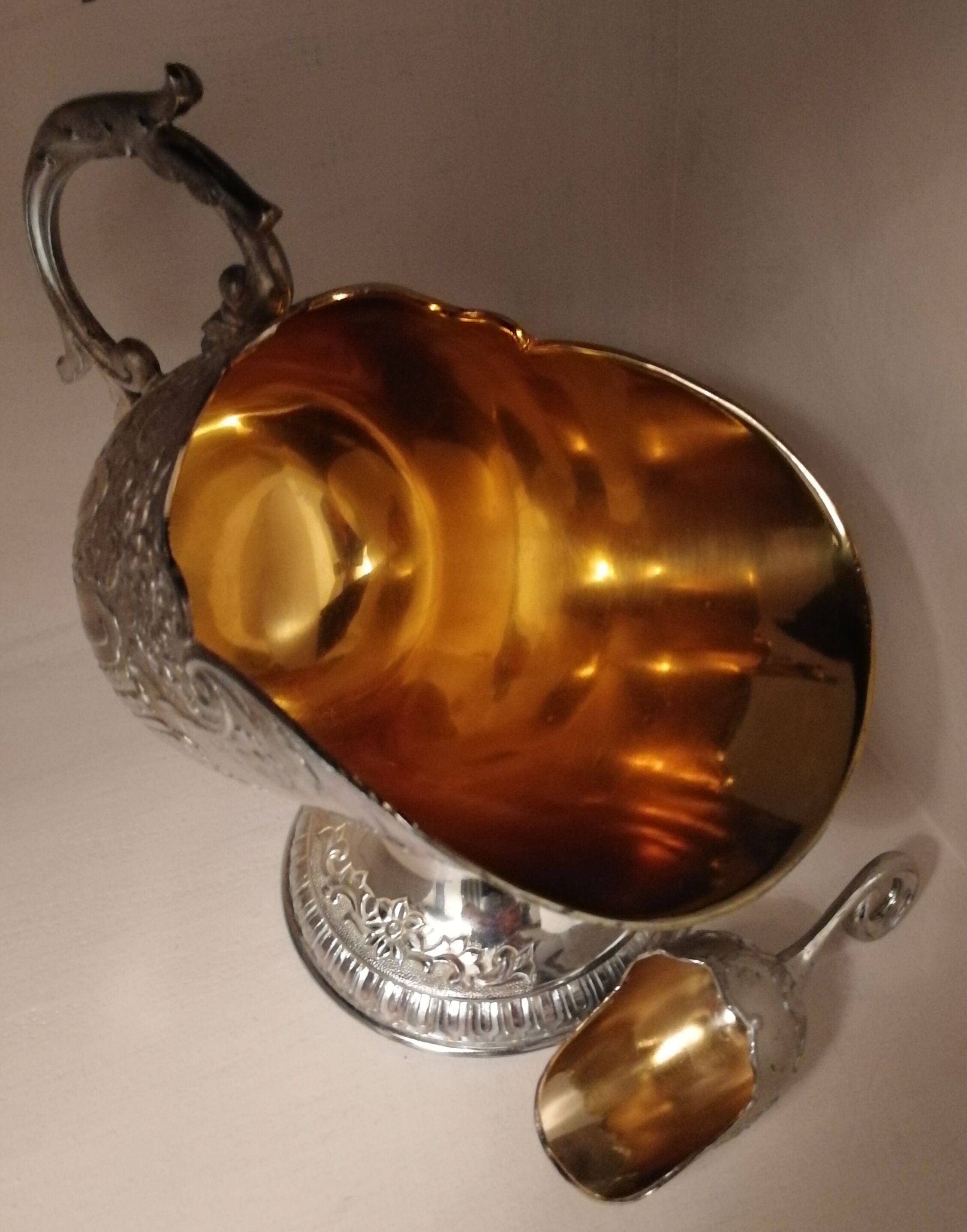 Sugar and sugar shovel in golden silver metal