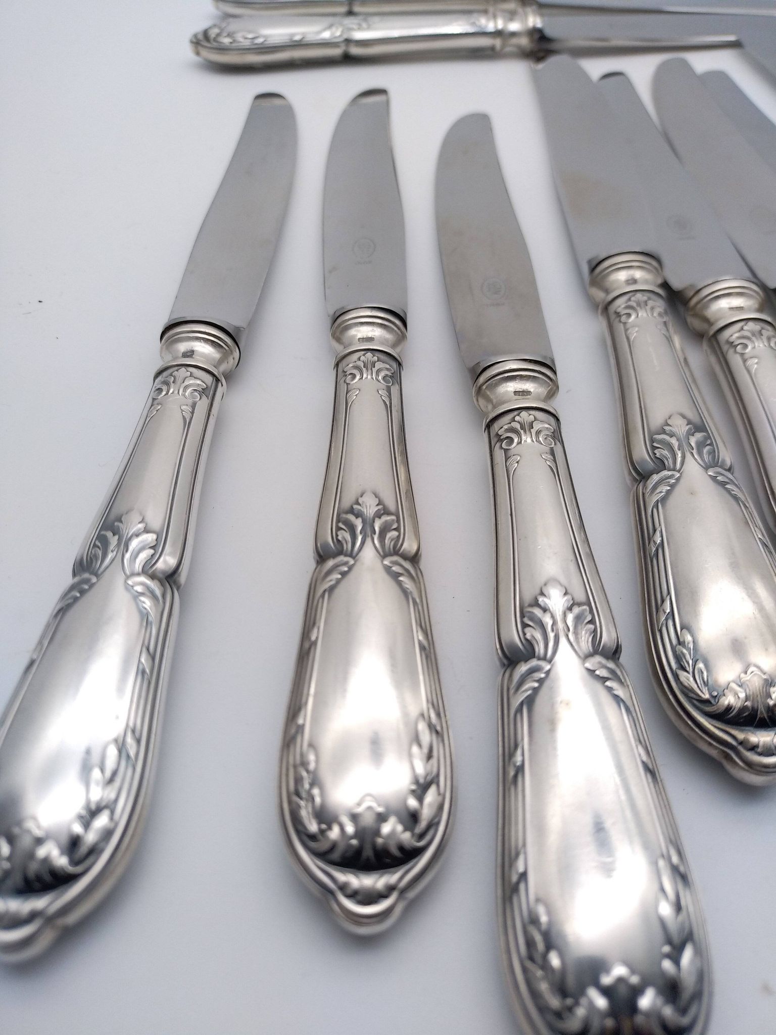 Set of 12 sfam knives in silver metal and stainless steel blades.