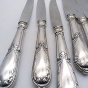Set of 12 sfam knives in silver metal and stainless steel blades.