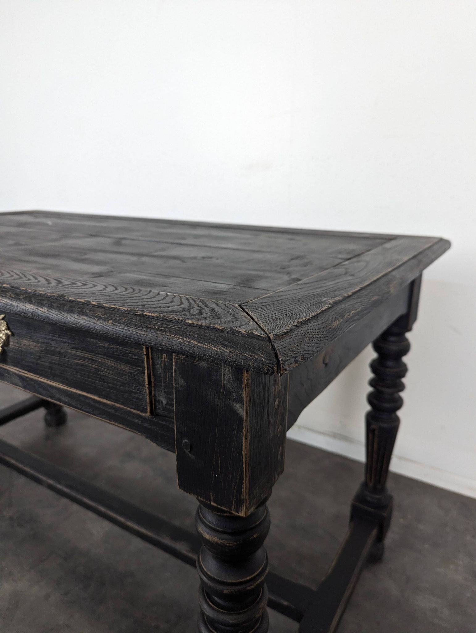 Louis XIII style desk in blackened wood with turned legs and two drawers.