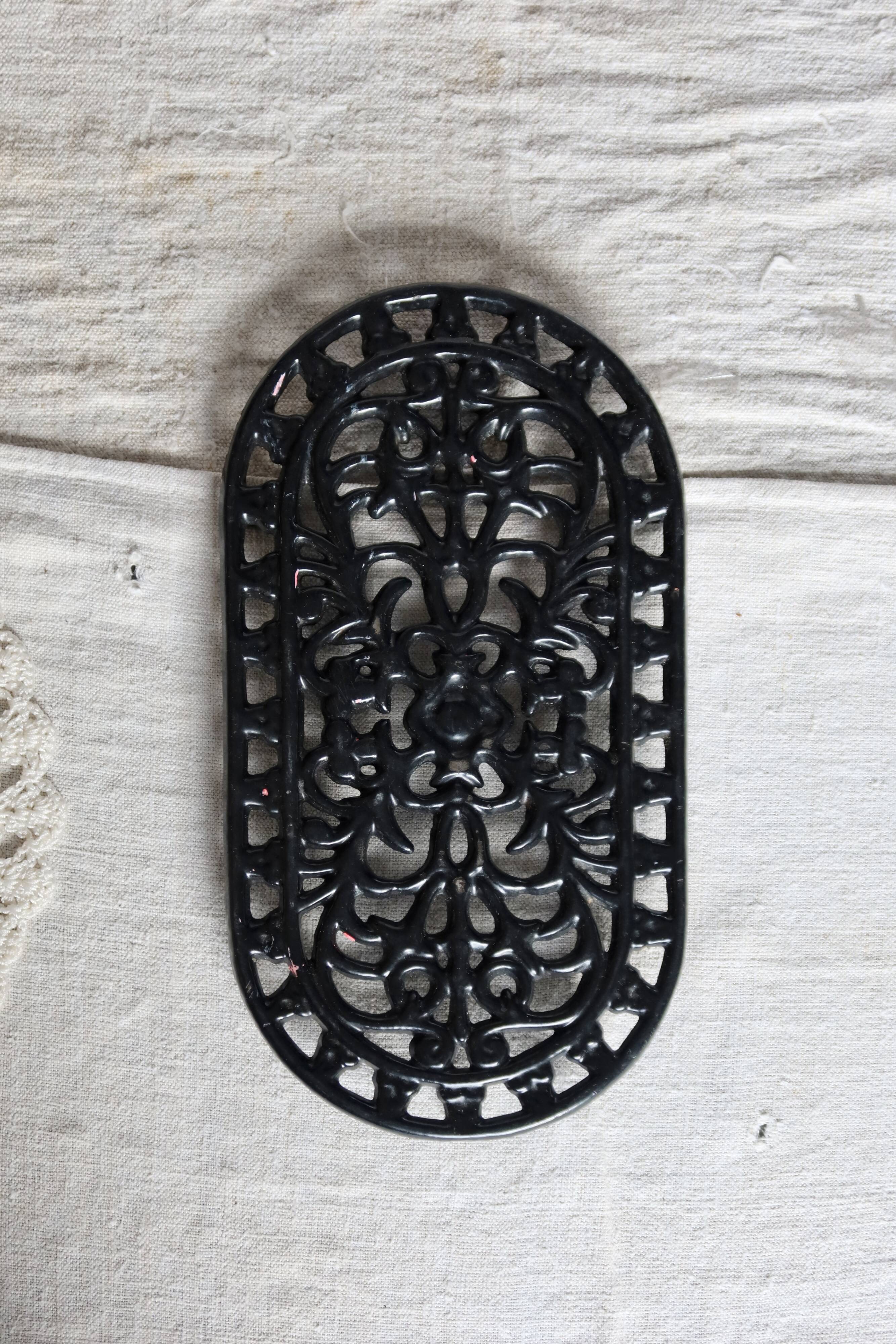 Vintage black cast iron oval trivet - Openwork design