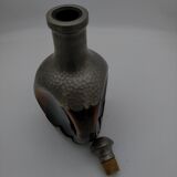 Vintage decanter in glass and tin.