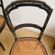 Set of 2 antique chairs in blackened wood and caned.