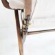 Pair of varnished wooden reclining armchairs, upholstered in lightweight fabric.