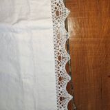 Ancient monogrammed pillowcase adorned with cotton lace