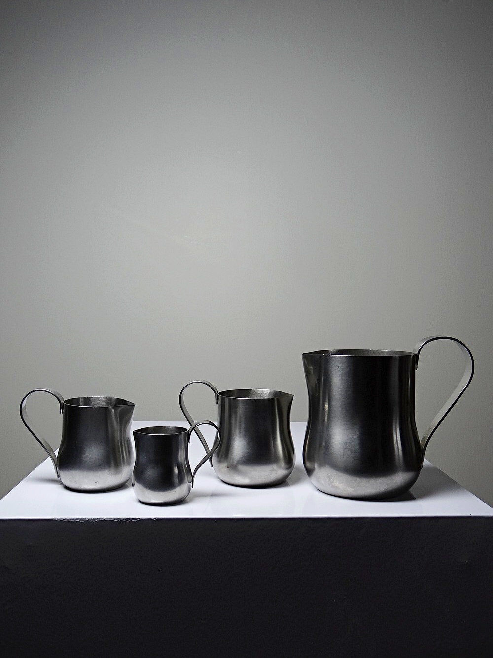 Set of 4 vintage bar measures in brushed stainless steel from the 60s-70s.