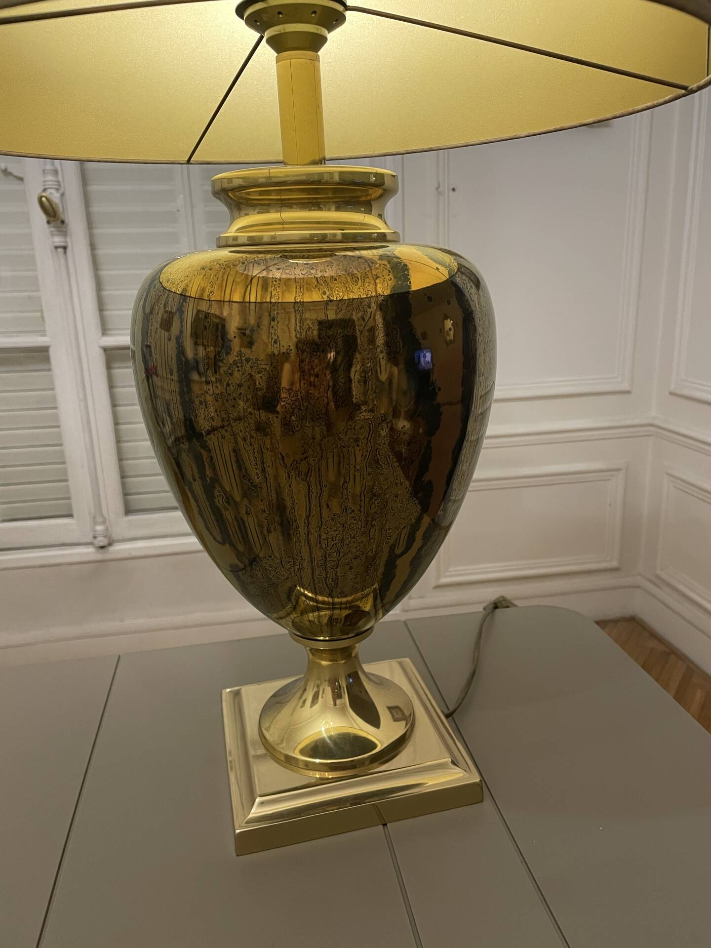 Bronze table lamp with a golden shade.