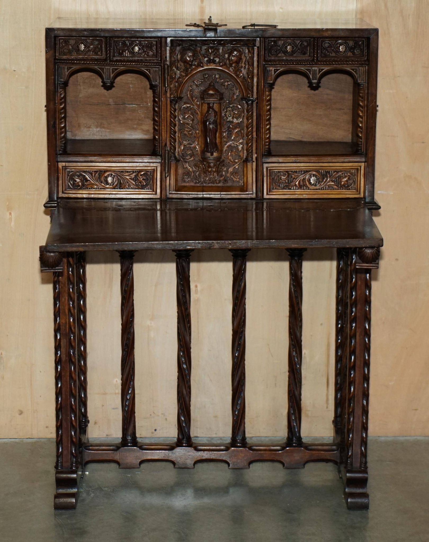 18th-century carved Spanish cabinet with hidden storage.