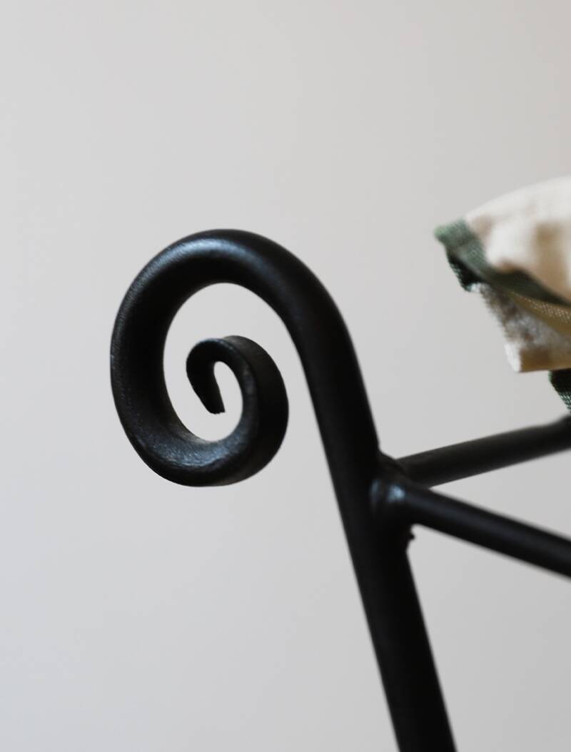 pair of wrought iron stools with cushions