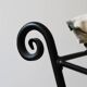 pair of wrought iron stools with cushions
