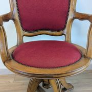 Vintage captain's chair in wood and garnet fabric — a seat with character