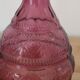 Vintage pink pressed glass carafe – retro decorative bottle with wooden stopper.