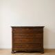 Antique wooden chest of drawers with a marble top.