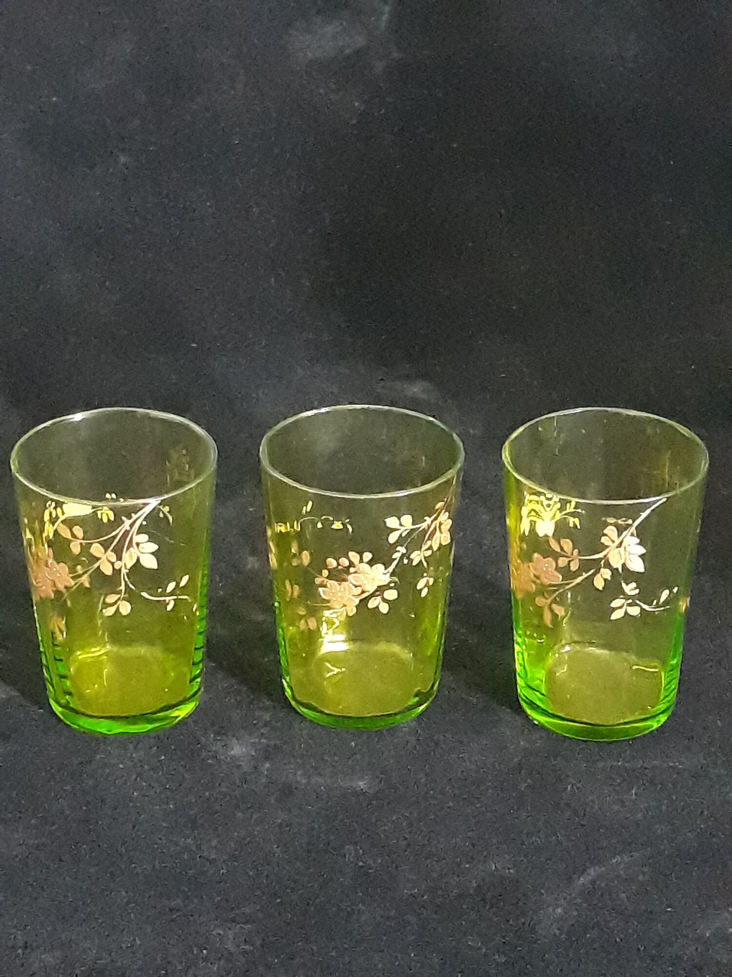 Small carafe and green glass drop glasses with rococo golden emailed decor