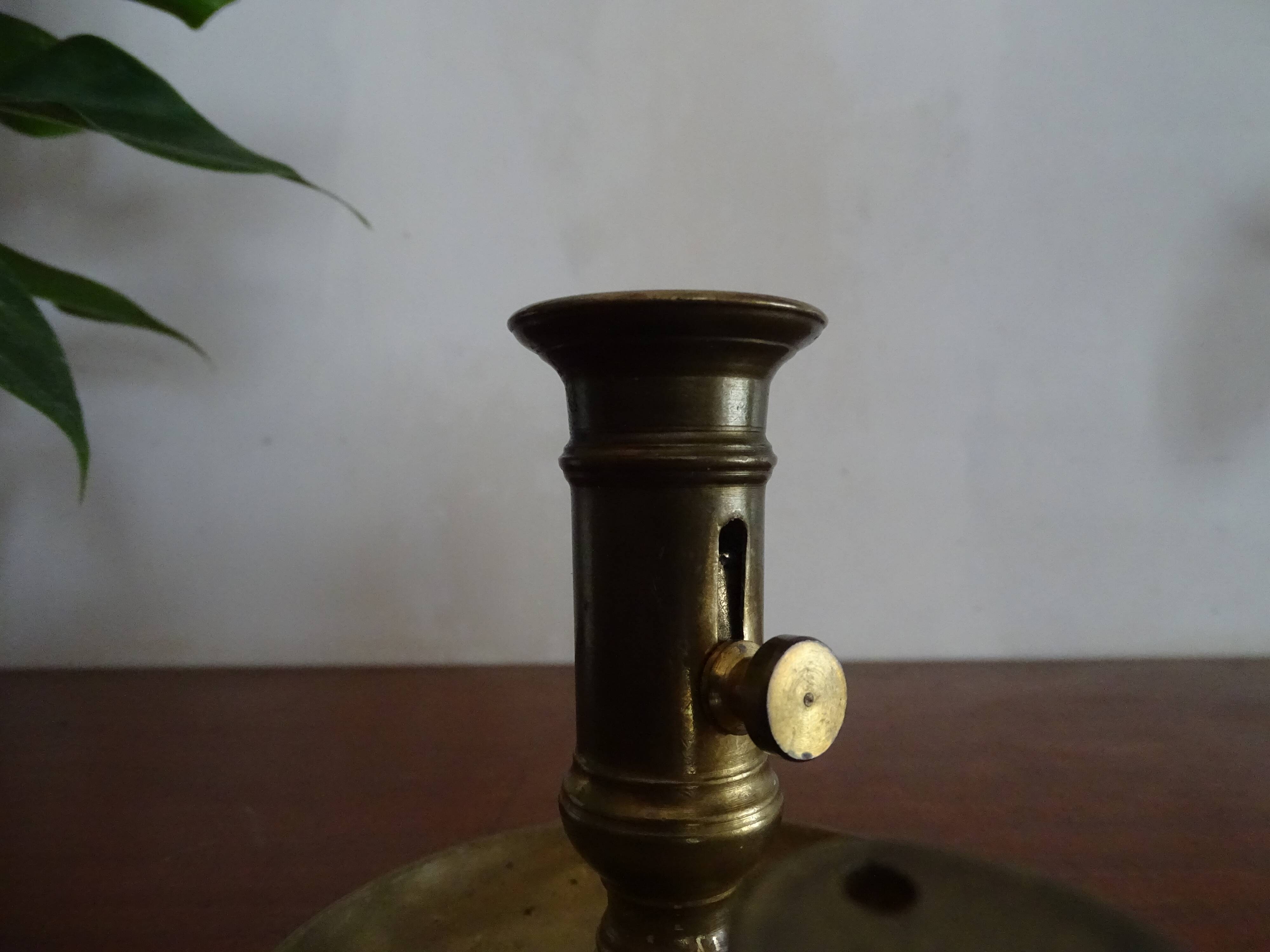 Pair of vintage brass pusher candle holders