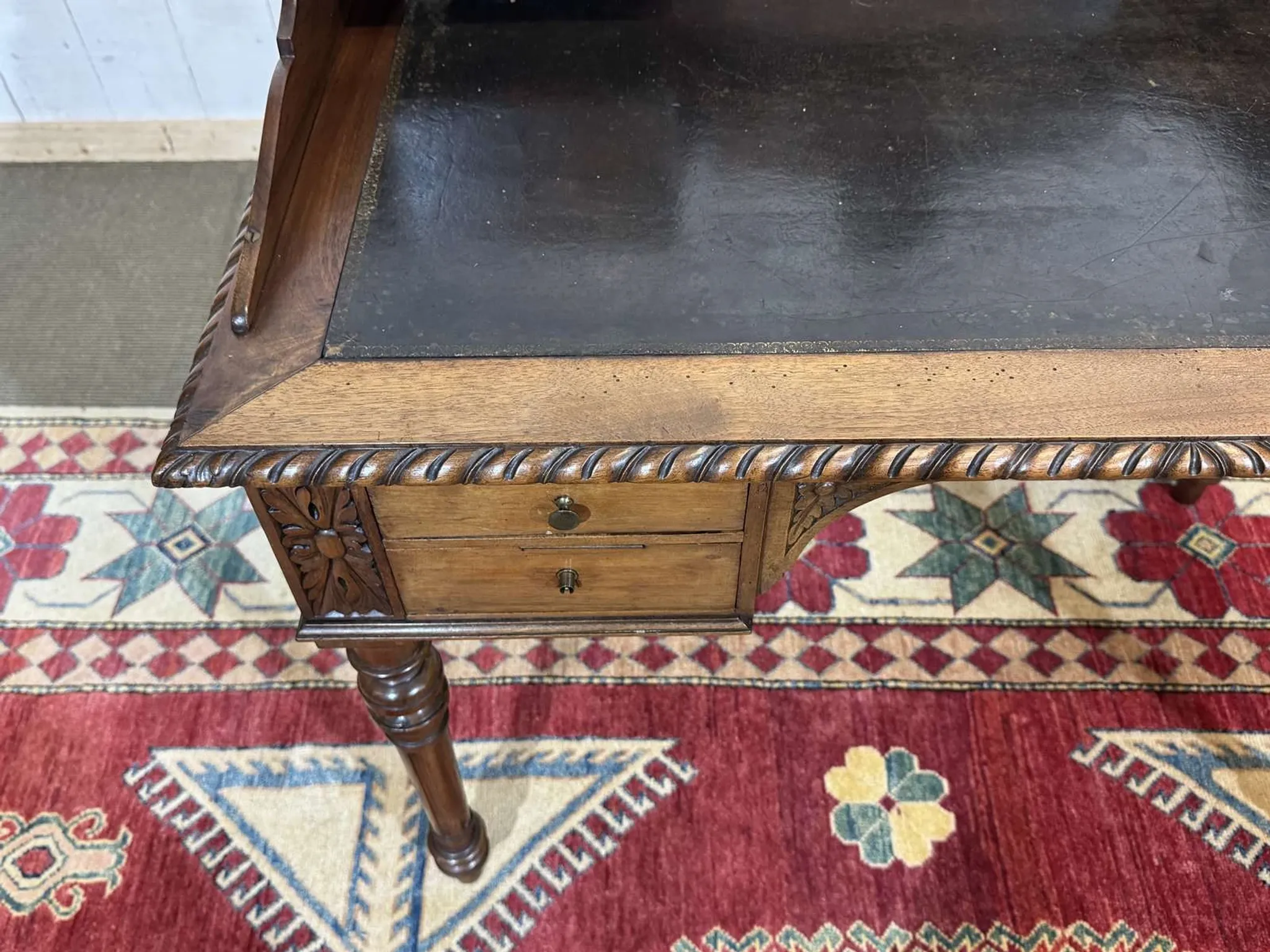 Louis XVI style desk from the late 19th century in walnut with a leather top.