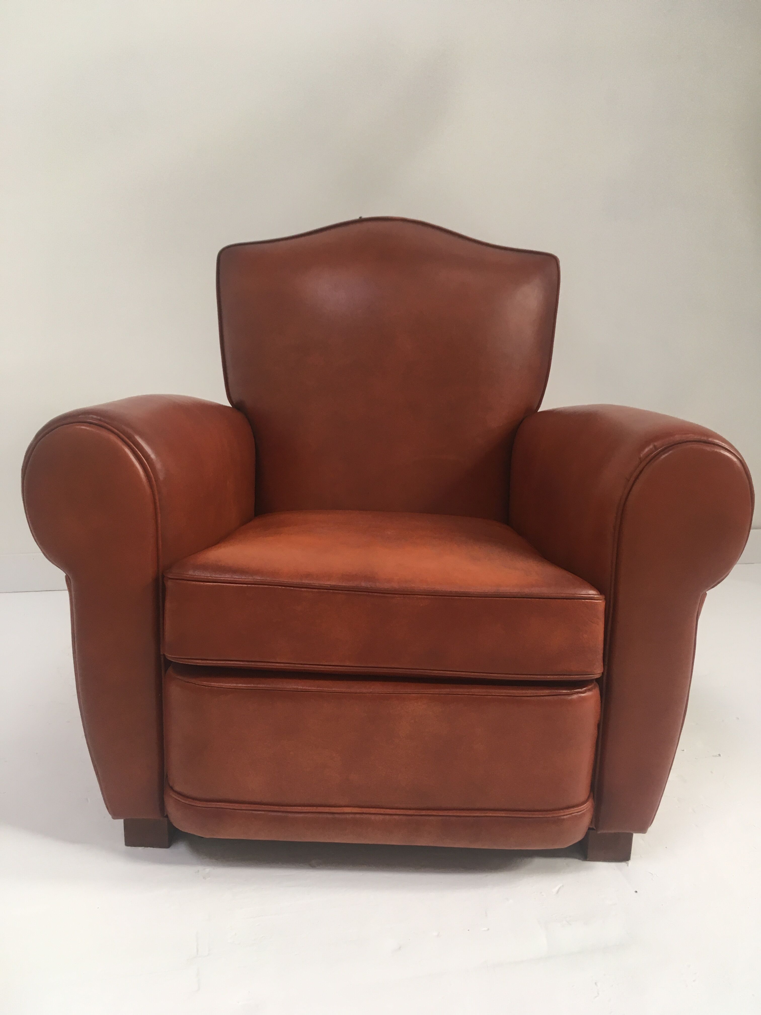 Large club chair in cognac leather