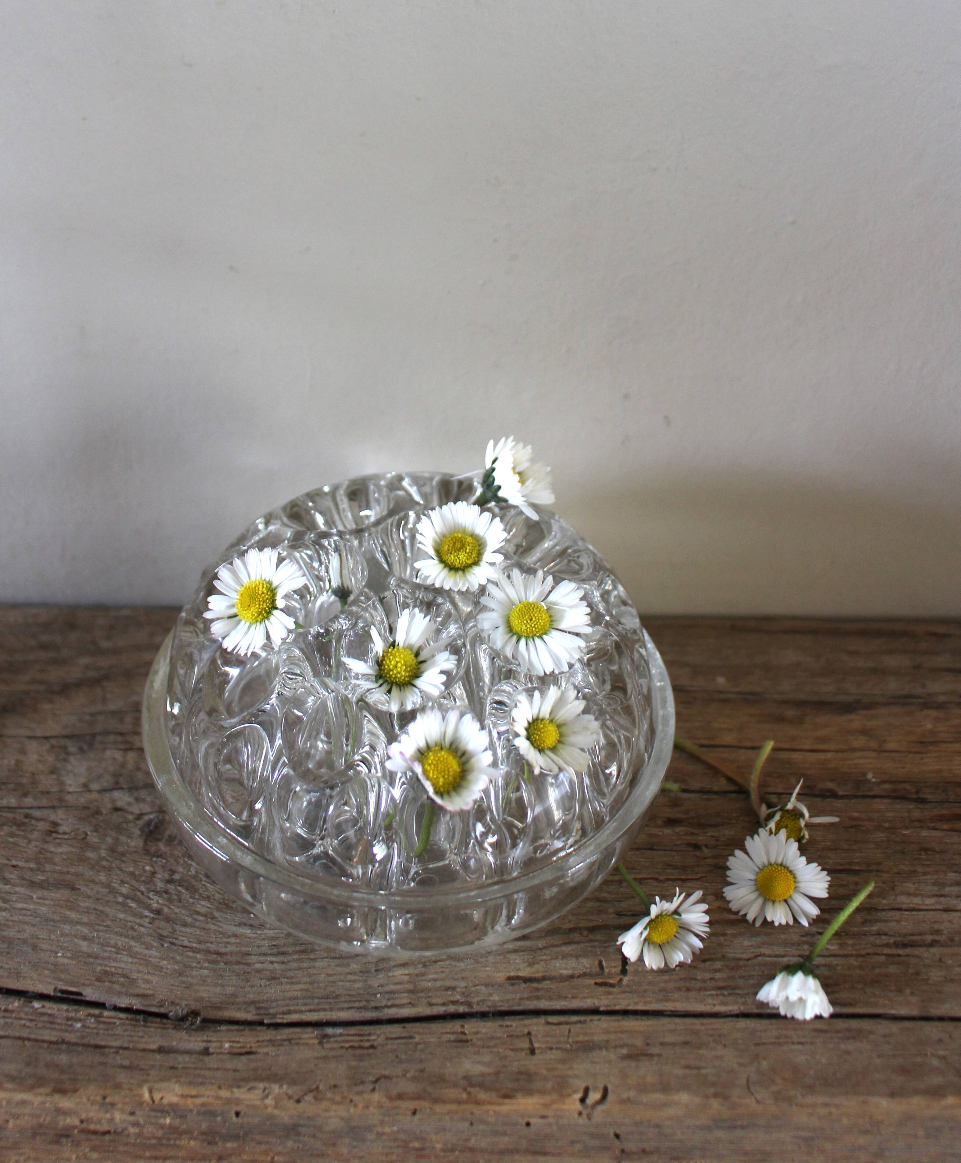 Large round glass flower frog vase with 19 holes.