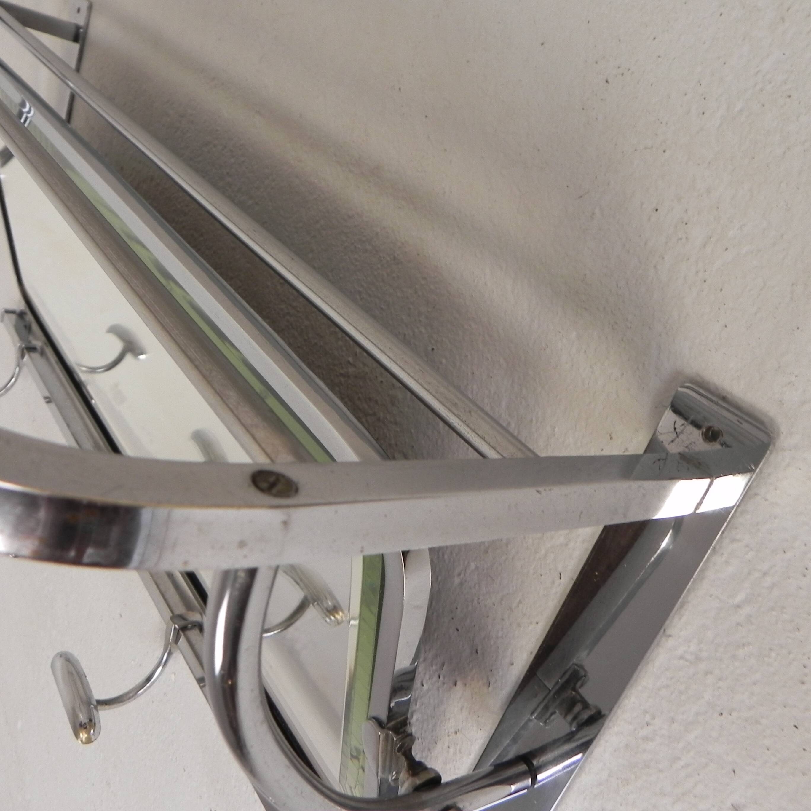 Art Deco wall coat rack with a bevelled mirror adjustable in a chrome frame, 1930s.