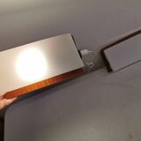 A pair of teak wood wall lamps with plastic shade.