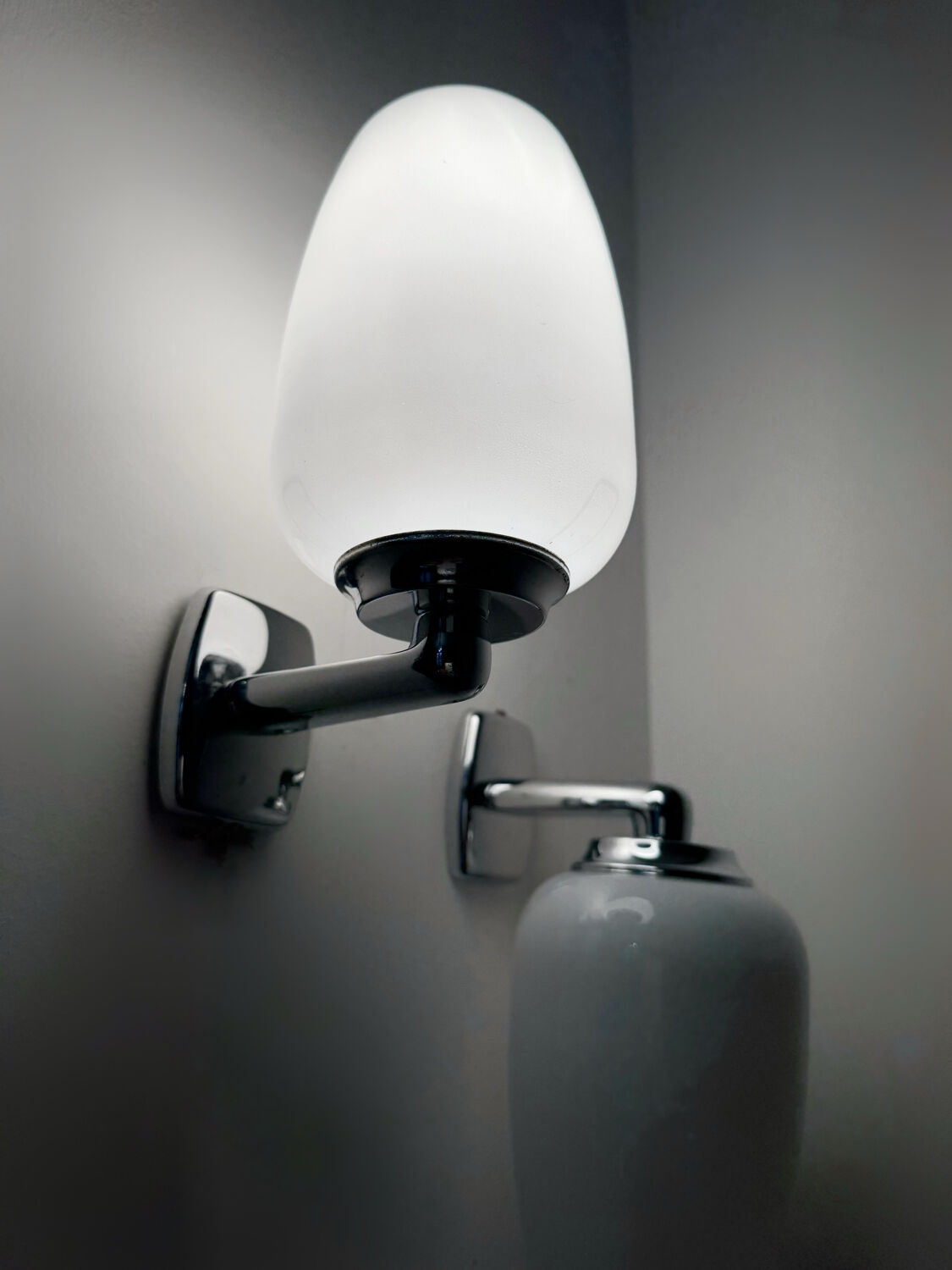 Chrome and opaline wall lights from the 70s.