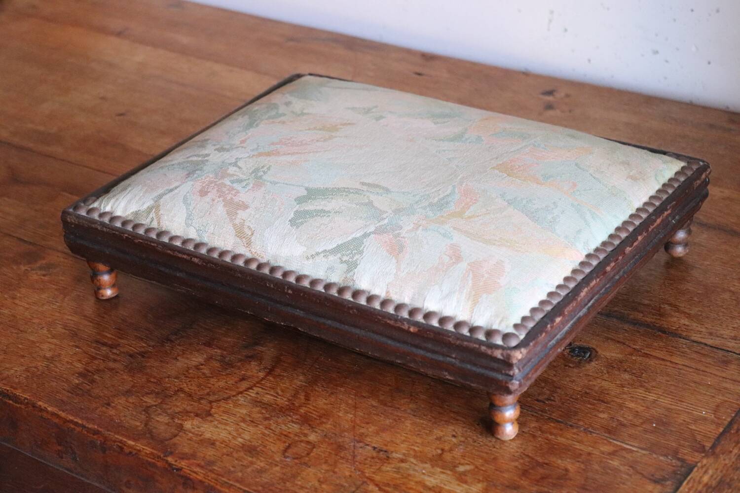 Small antique wooden and fabric footrest.
