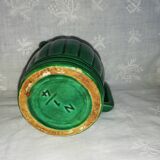 Old green pitcher in dabbling