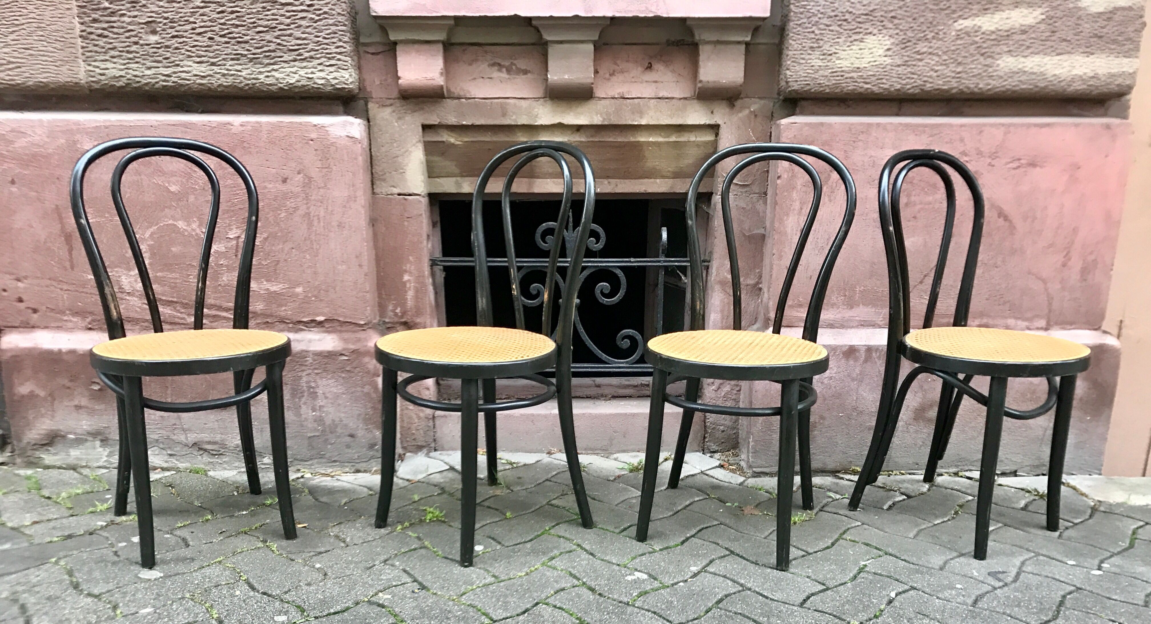 Two pairs of black 50s chairs - number 18 - cannée