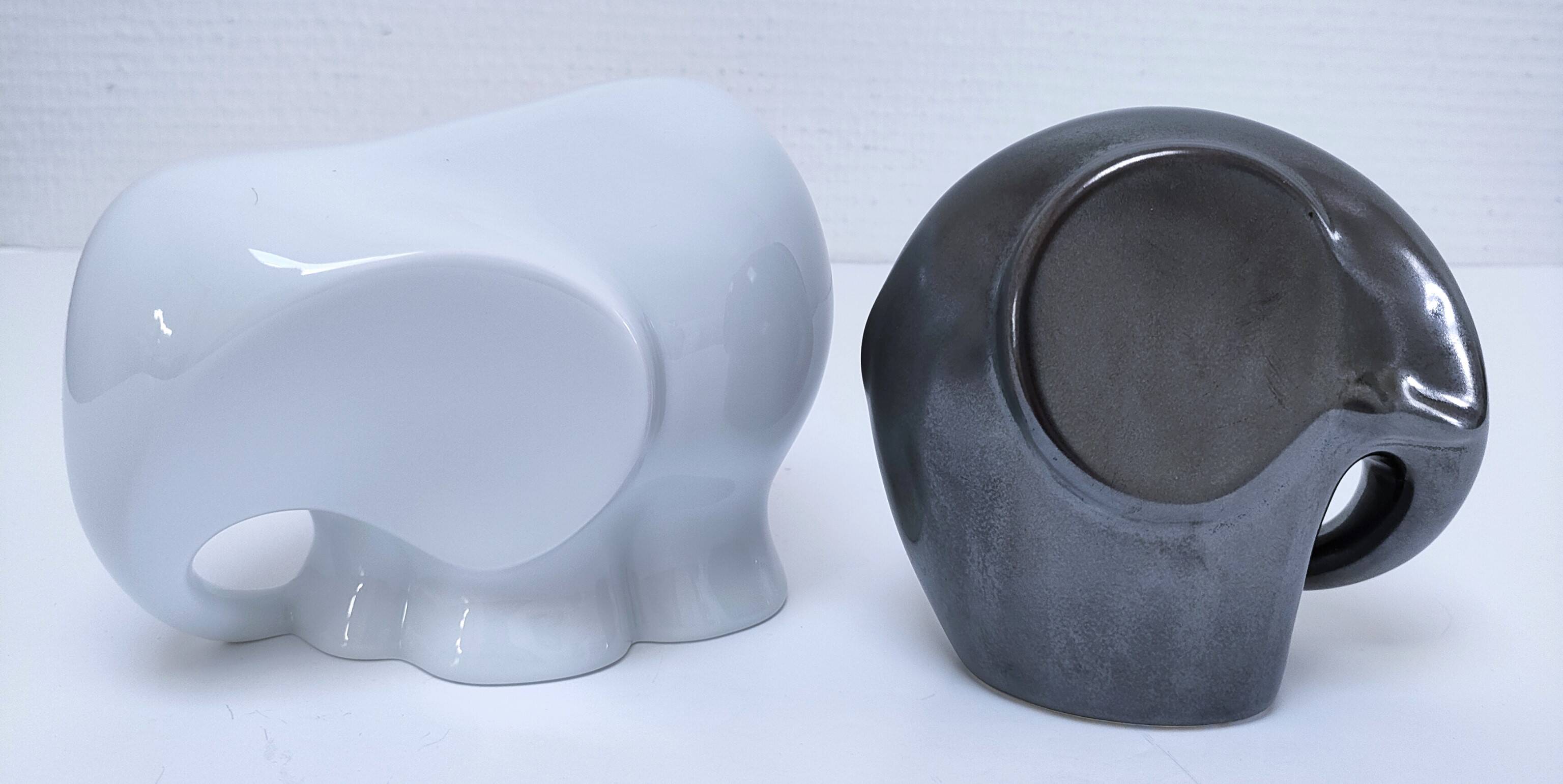 Two iridescent black and white ceramic elephants design