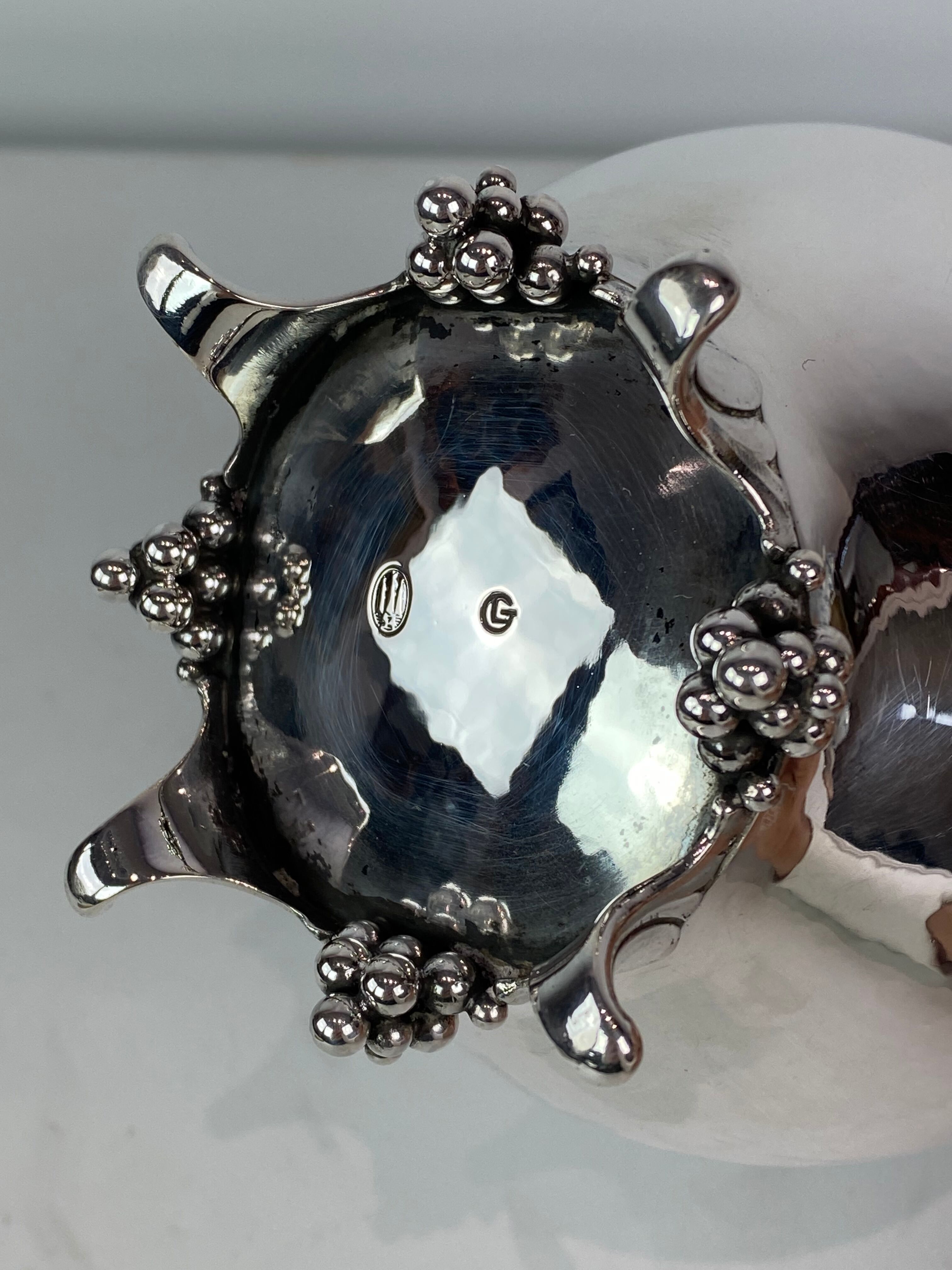 Water jug on feet decorated with ebony of hallmarked silver from the 1940s. The jug is in great anti