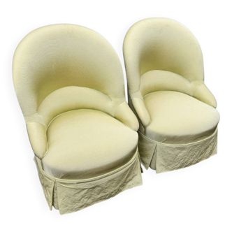Pair of upholstered frog chairs in pastel apple green.