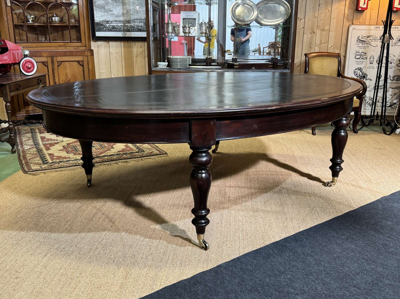 Large English library table in dark walnut with a leather top.