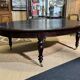 Large English library table in dark walnut with a leather top.