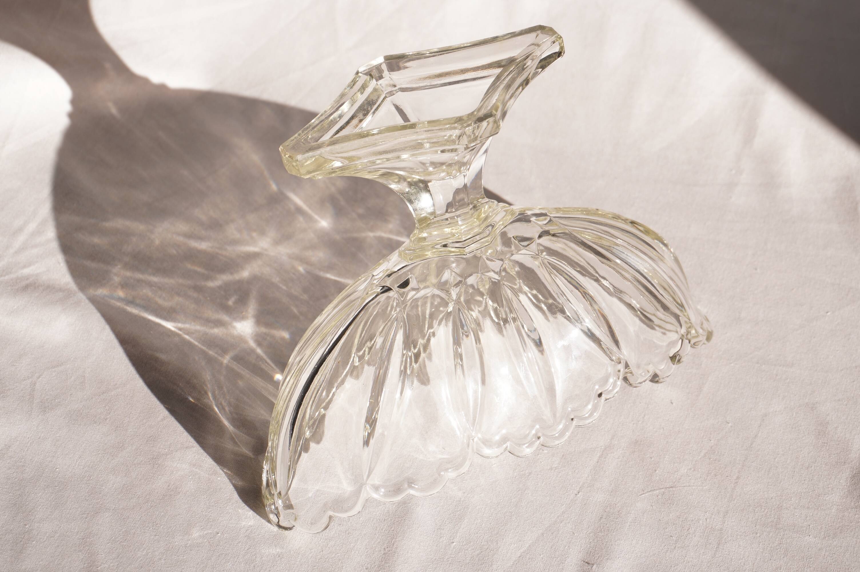 Oval glass fruit bowl on a stand.