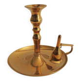 Old candlestick with brass extinguisher.