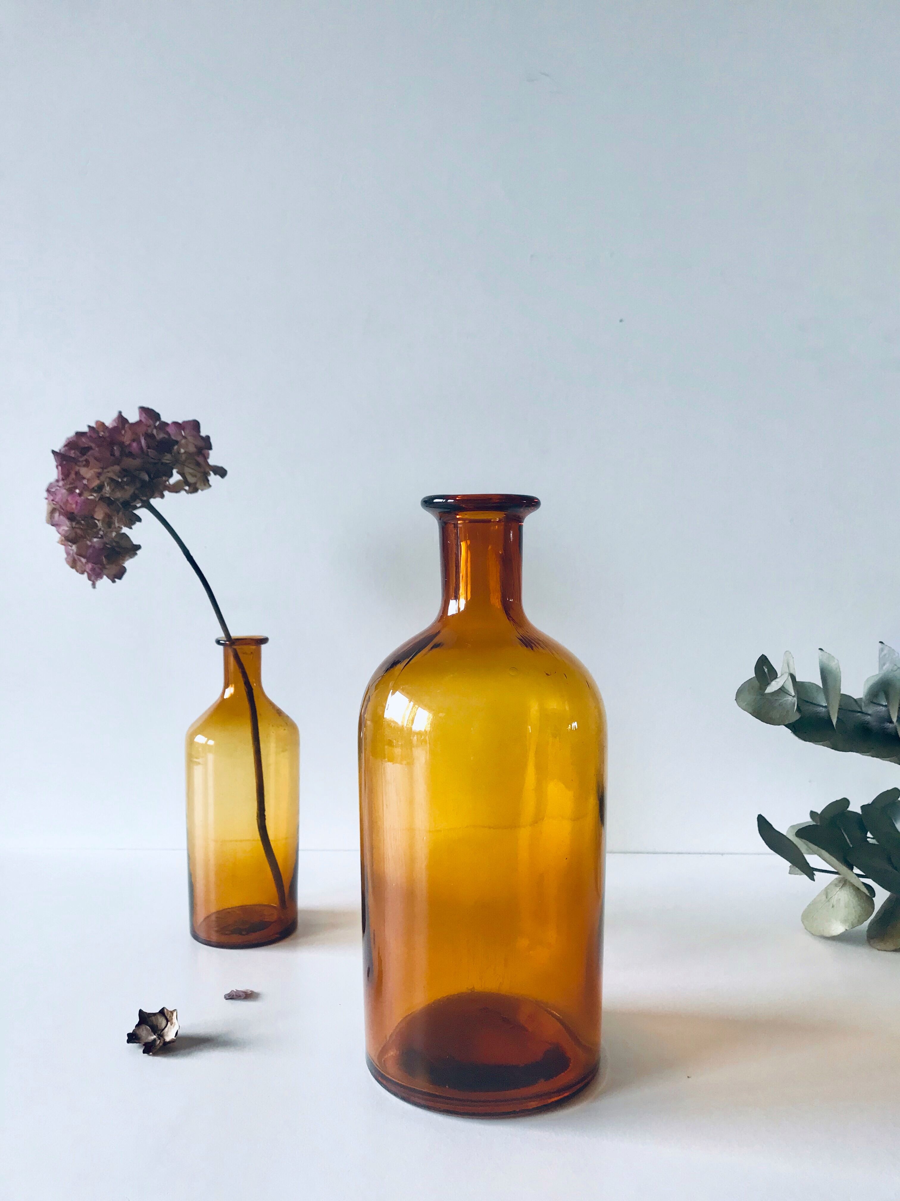 Duo of ancient apothecary flakes in amber glass