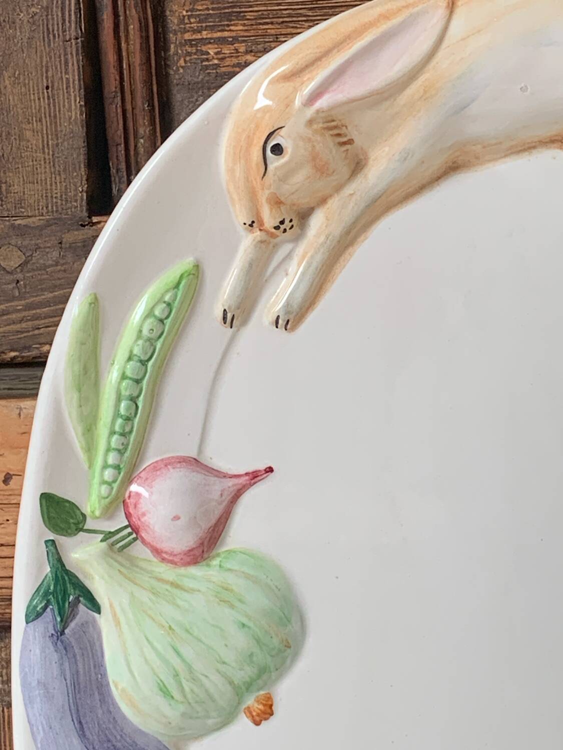 Very large serving dish with hares and vegetables.