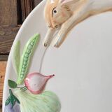 Very large serving dish with hares and vegetables.