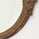 Pair of oval wooden windows with golden patina