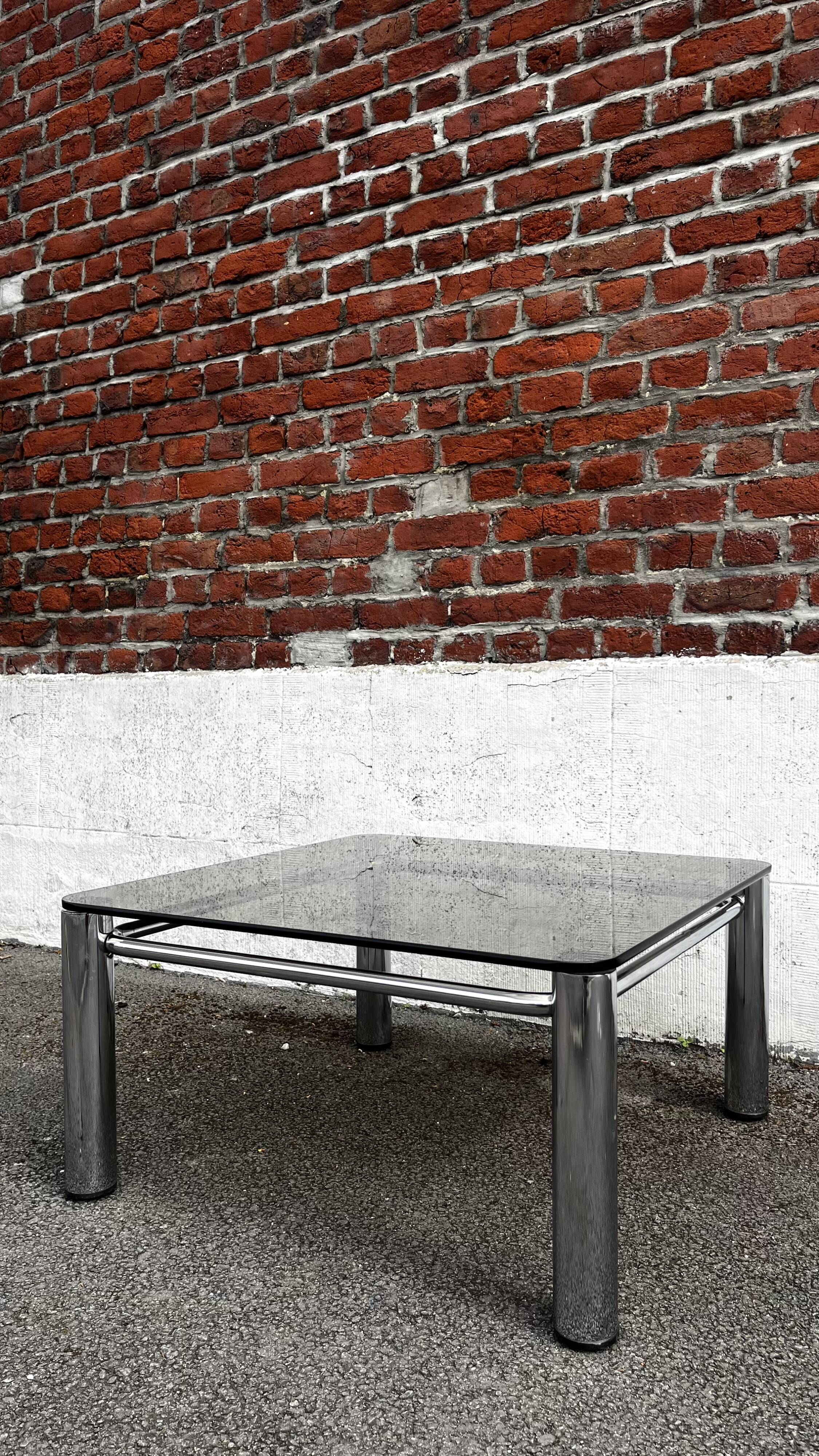Vintage smoked glass coffee table with chrome structure.